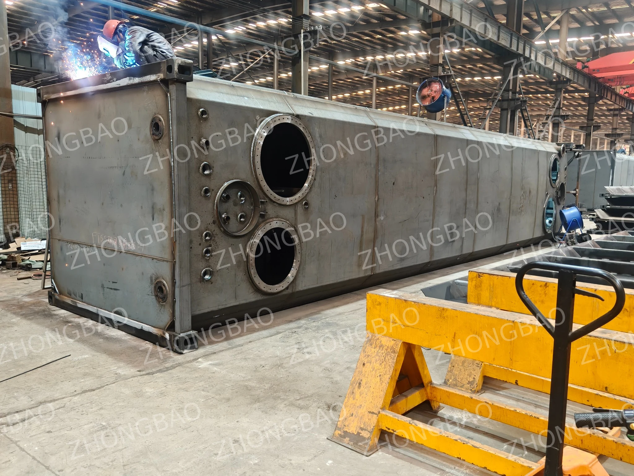 Tank end panel with service openings and pipe interfaces